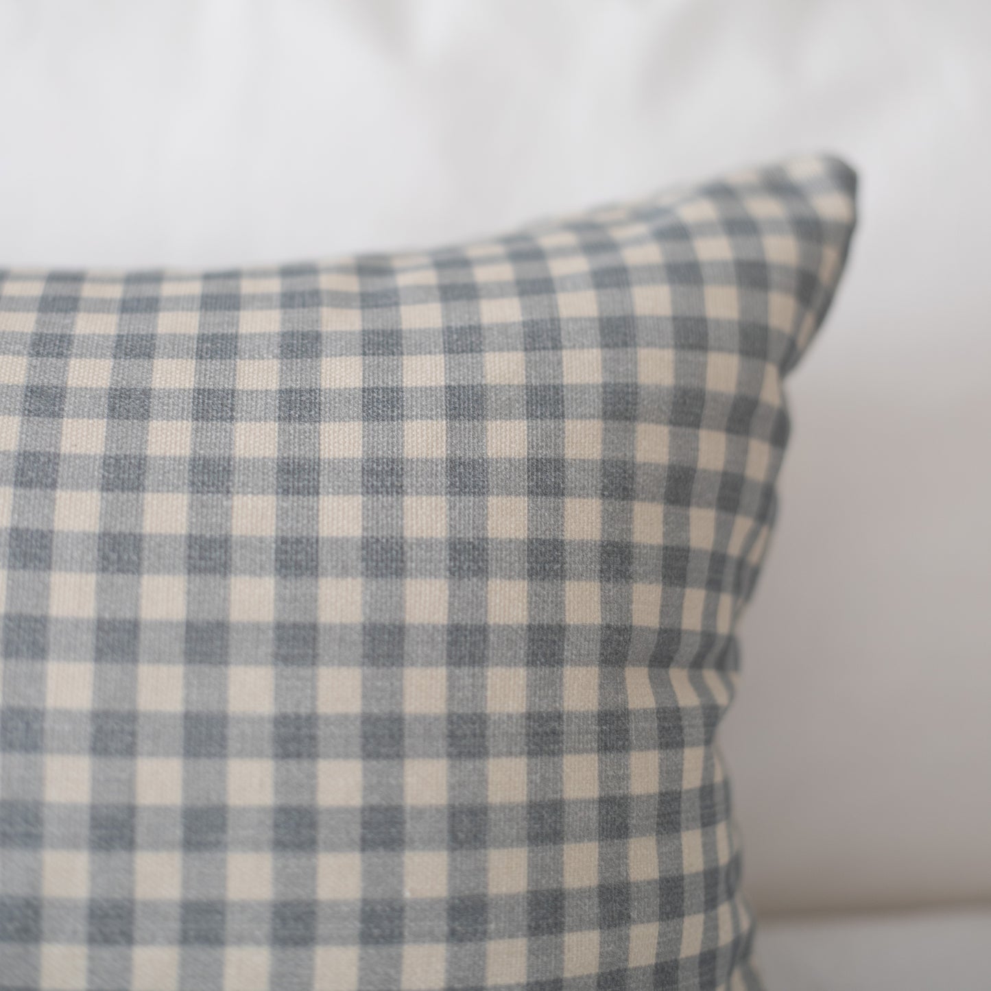 Dusty blue and cream gingham checkered pillow cover with woven texture.