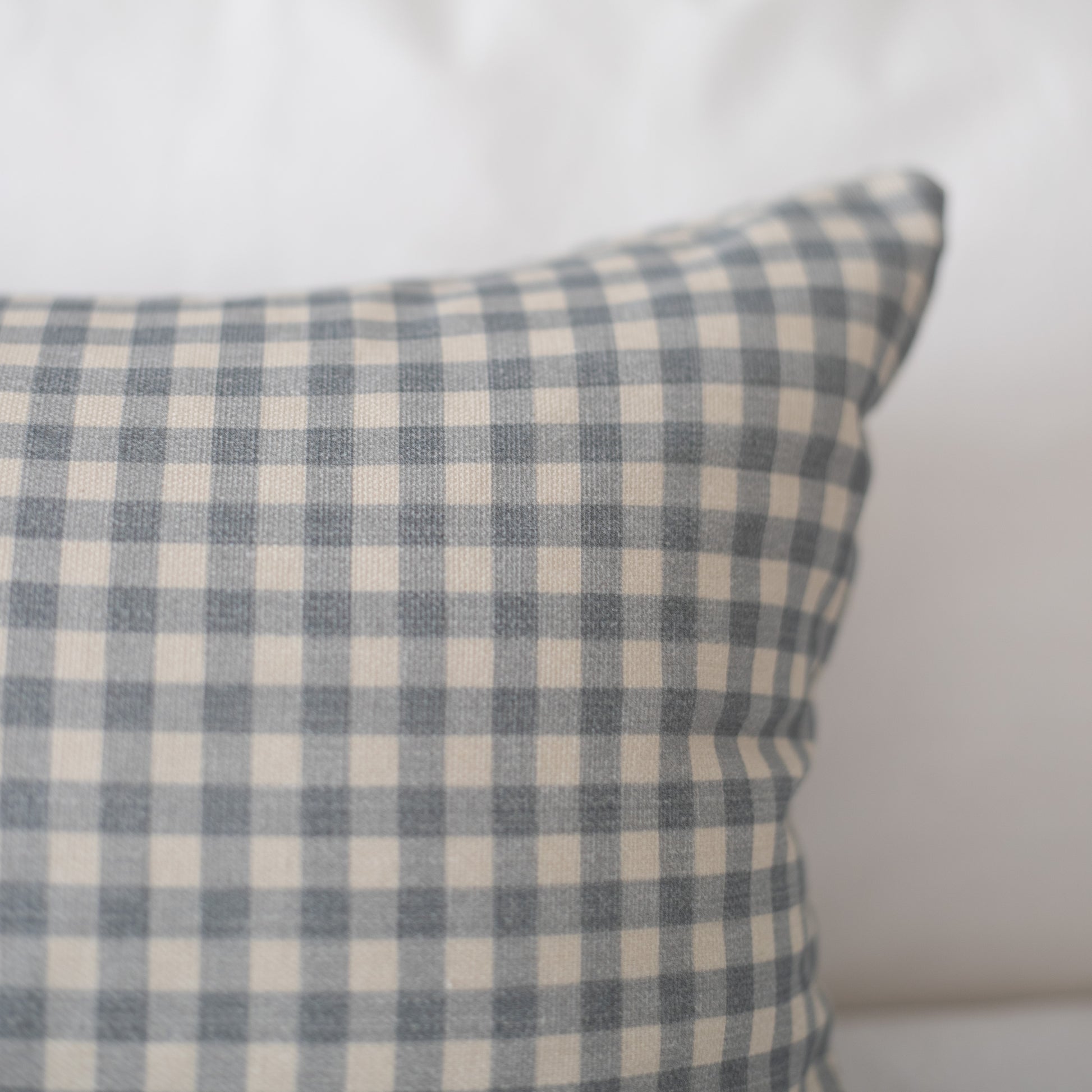 Dusty blue and cream gingham checkered pillow cover with woven texture.