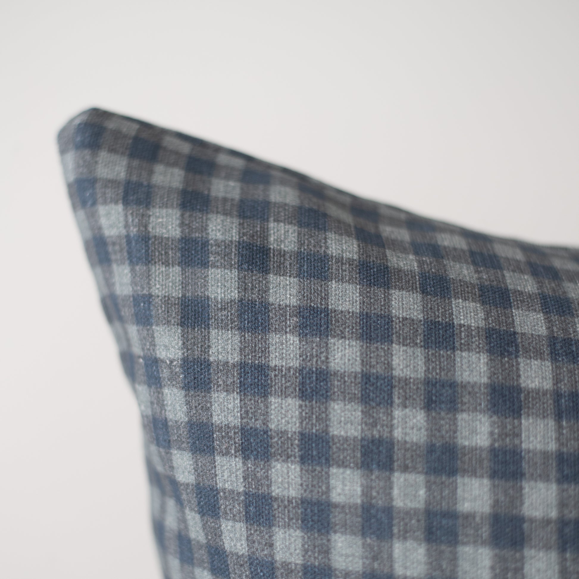 Navy and white gingham patterned pillow cover with checkered weave texture.