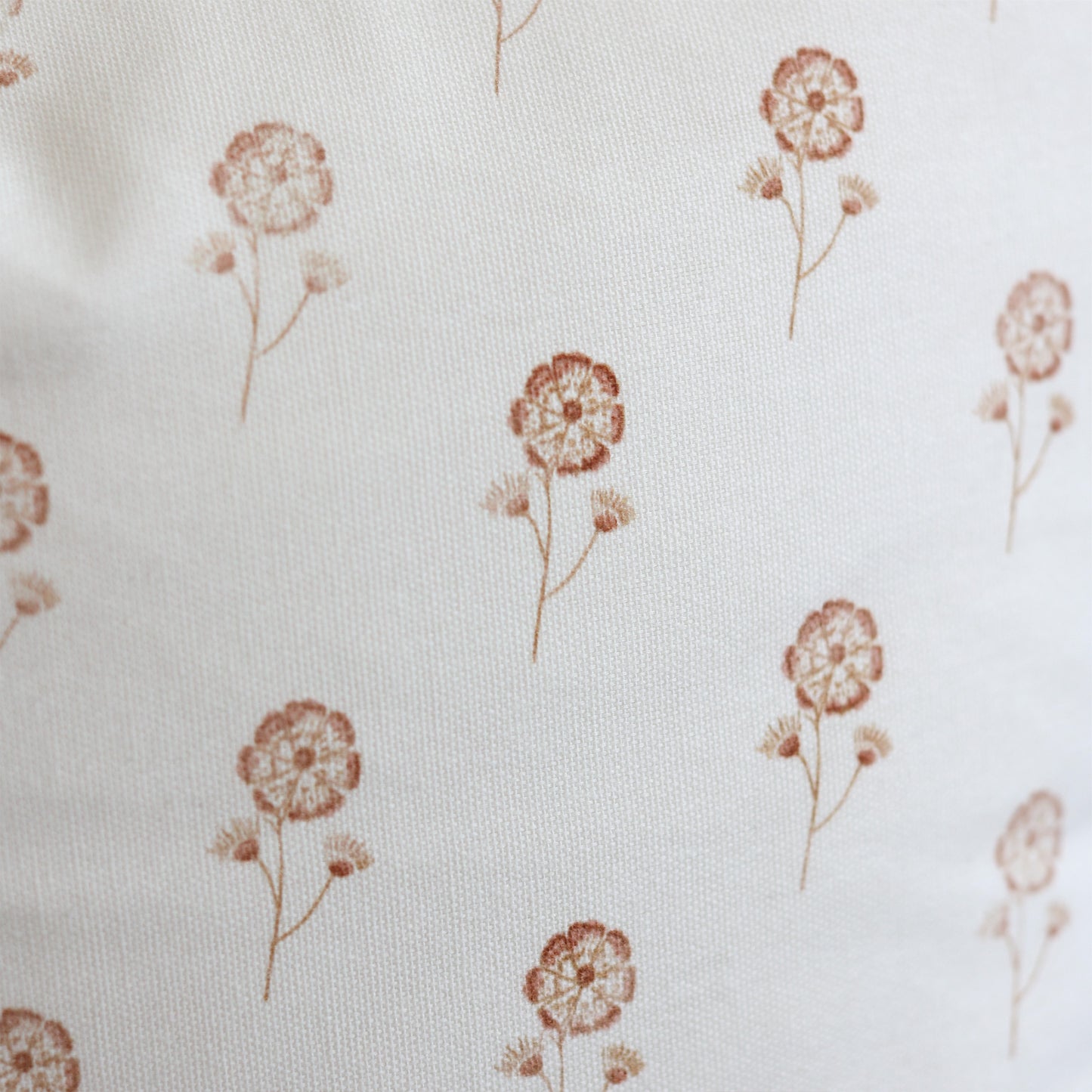 Cream fabric with scattered rust-colored dandelion flower pattern.