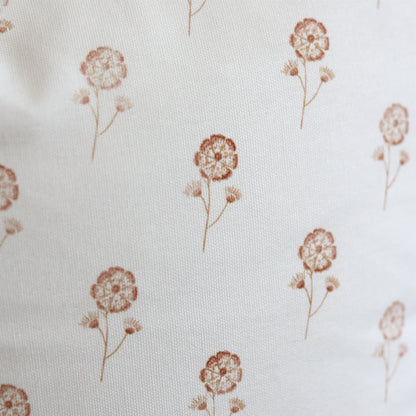 Cream fabric with scattered rust-colored dandelion flower pattern.