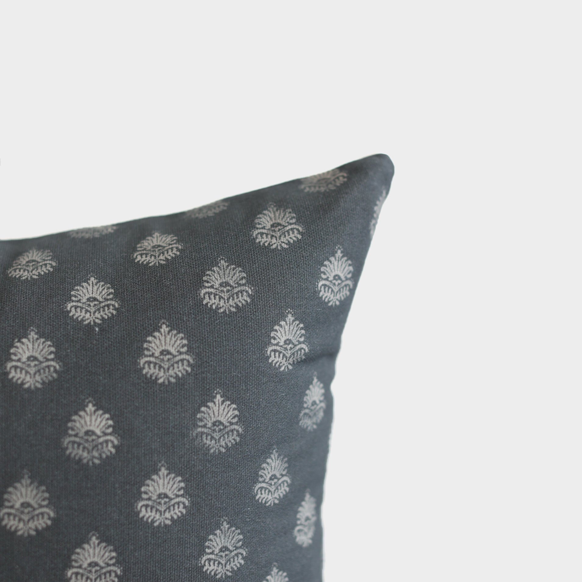 Blue lumbar pillow with cream damask pattern throughout.