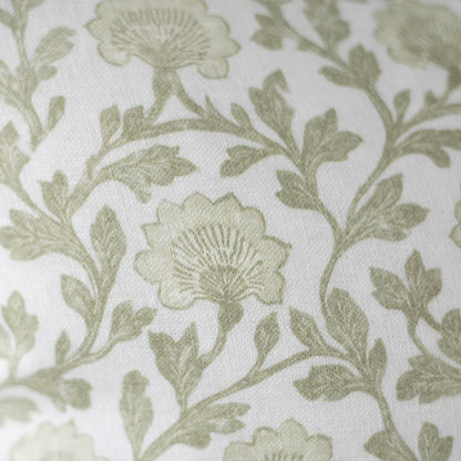 Sage green floral and leaf pattern on cream linen fabric with textured weave.