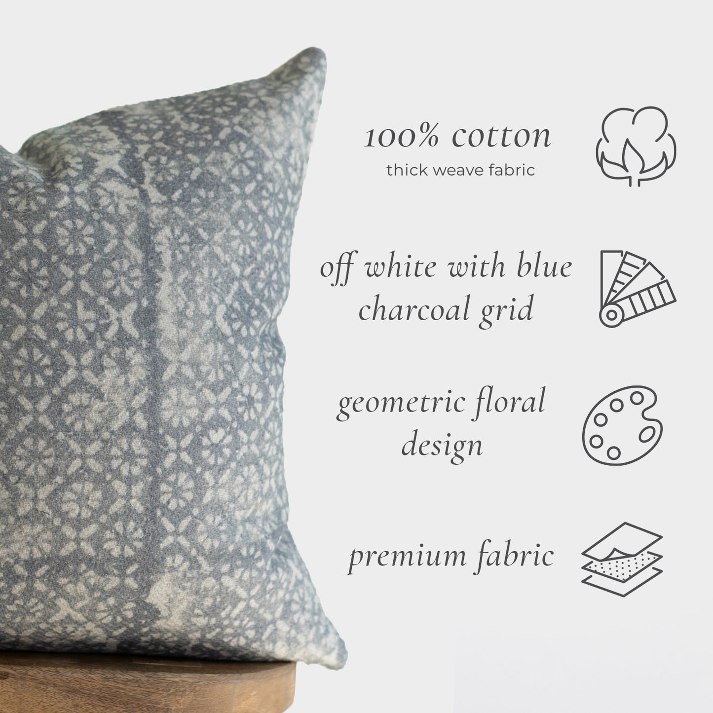 Off-white and blue charcoal cushion with geometric floral pattern, 22 inches.