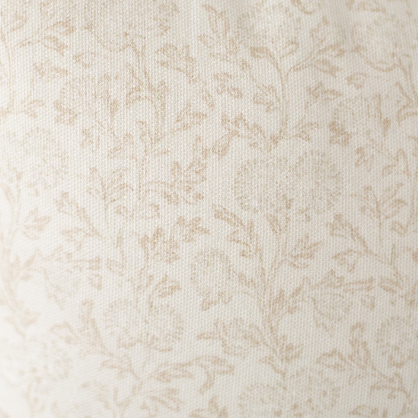 Cream and beige damask pattern on textured fabric surface.
