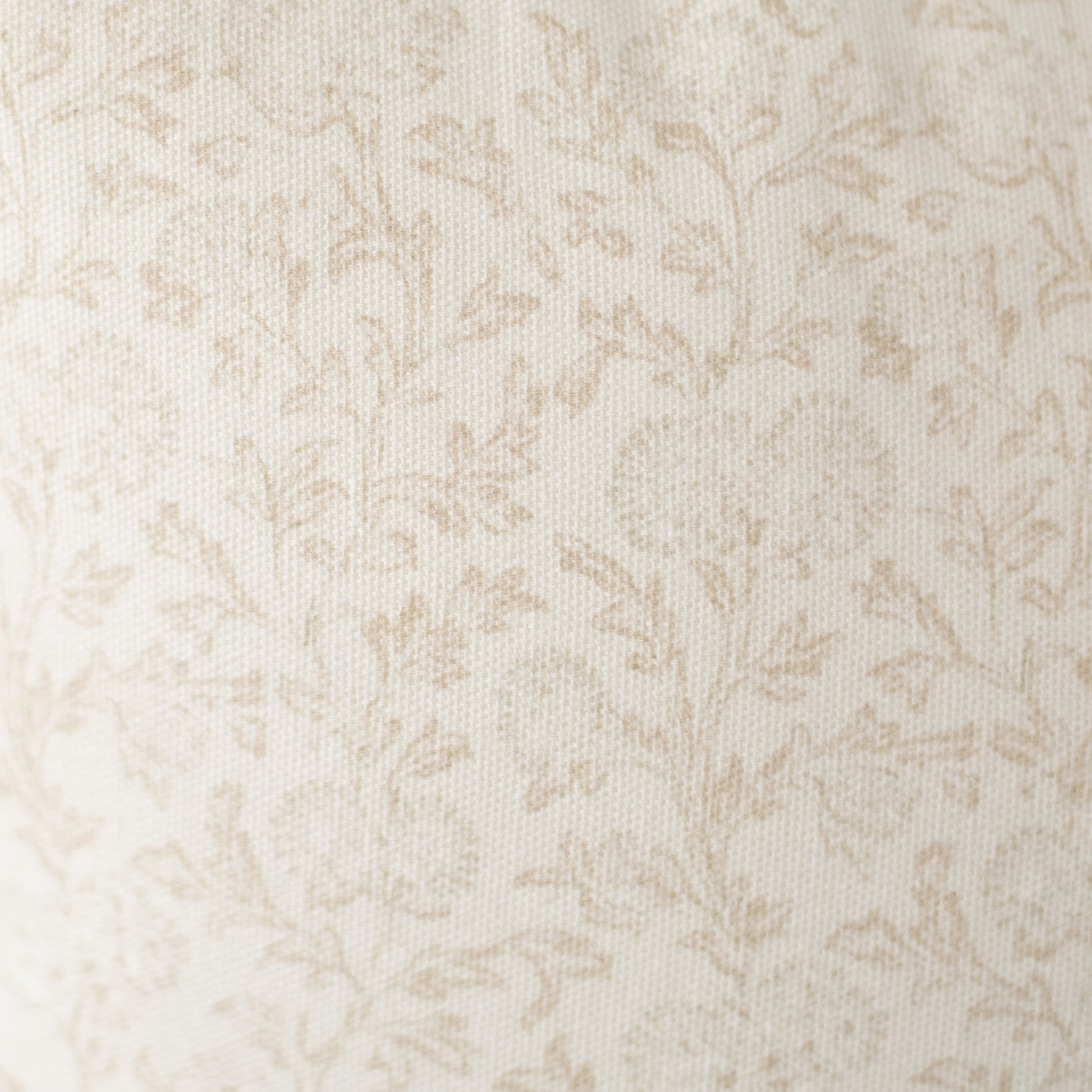 Cream and beige damask pattern on textured fabric surface.