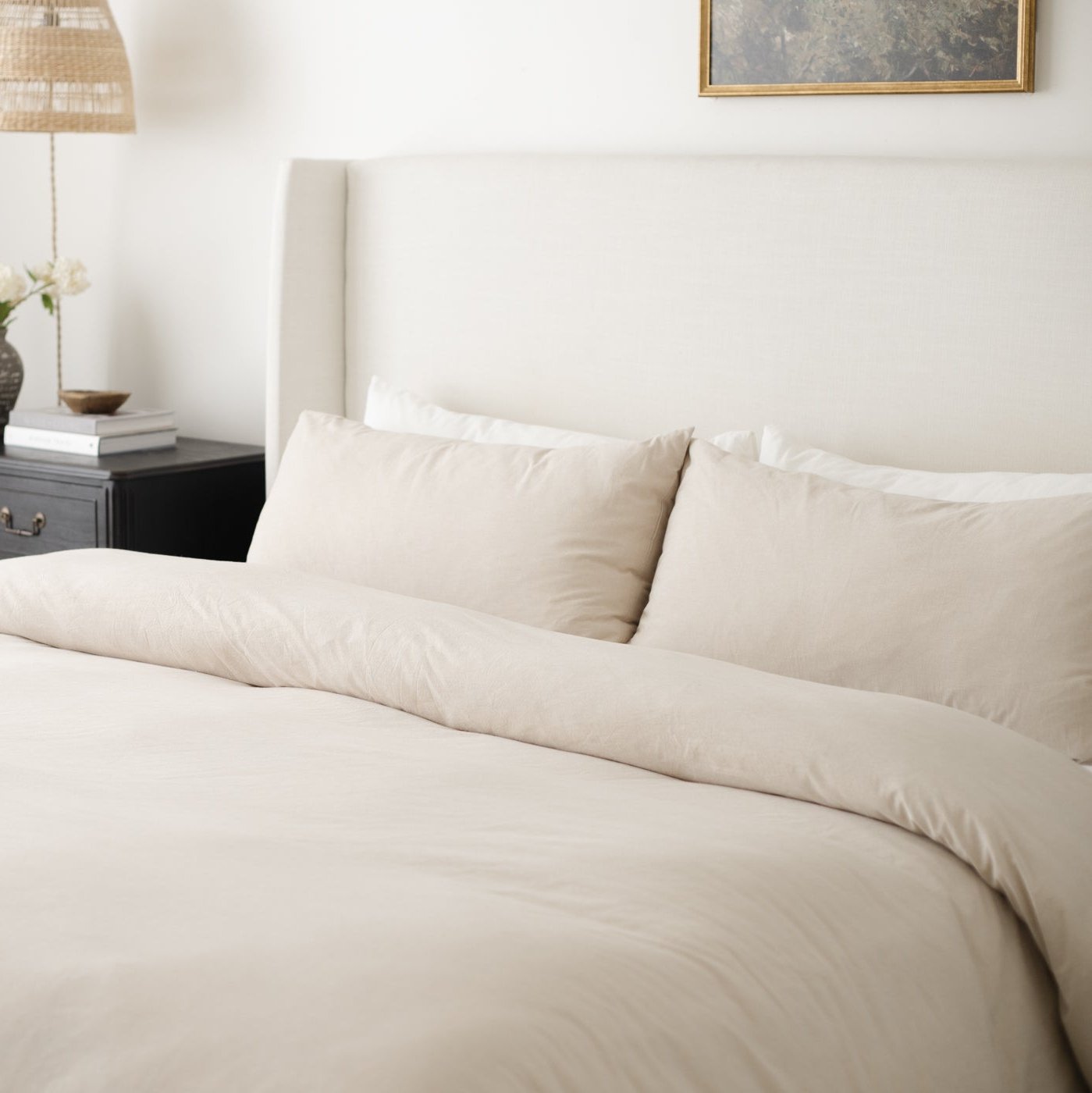 Beige duvet cover and pillowcases on a king bed with matching neutral bedding.