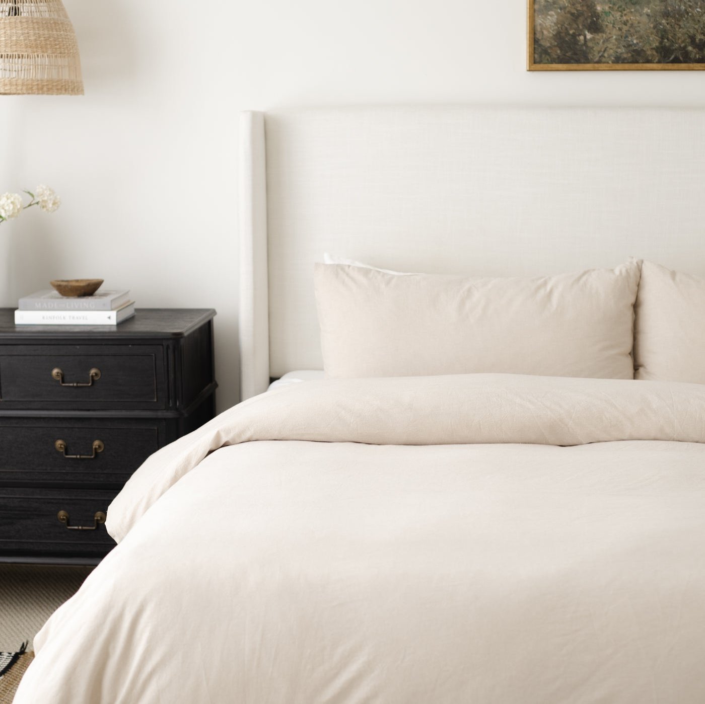 Beige duvet cover and pillowcases on a king bed with matching bedding and decorative pillows.