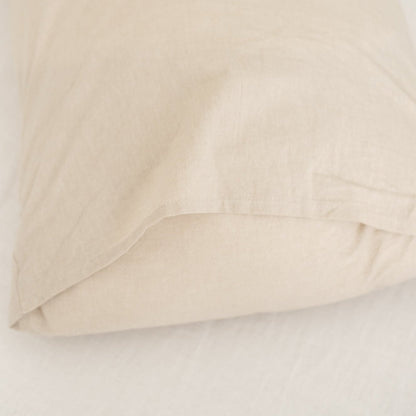 Beige duvet cover folded and layered, showing smooth fabric texture and neutral color.