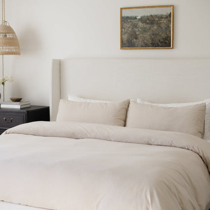Beige duvet cover set on king bed with matching pillowcases and neutral bedding styling.