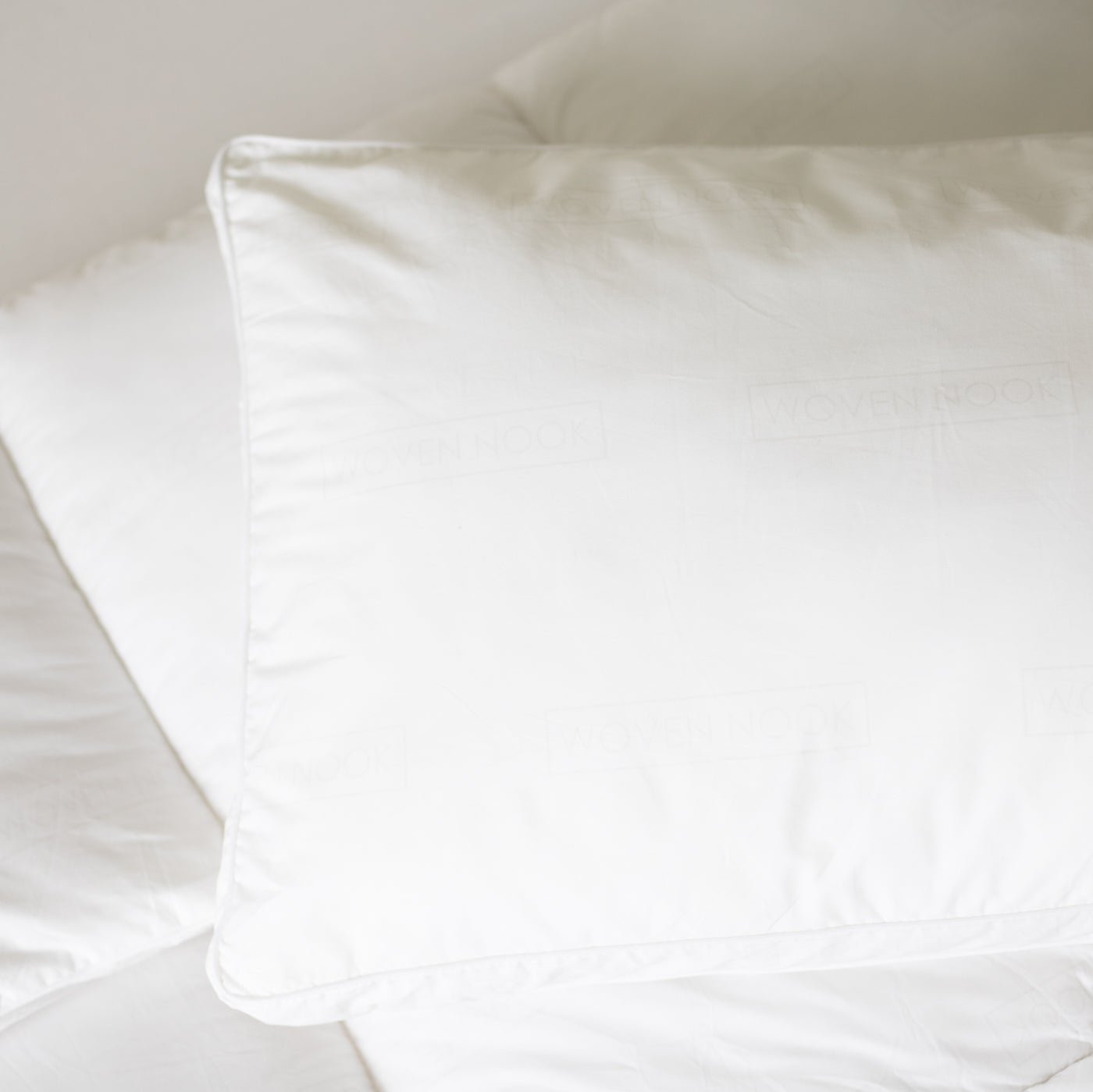 White king-size sham pillow with quilted faux down fill and piped edge detail.