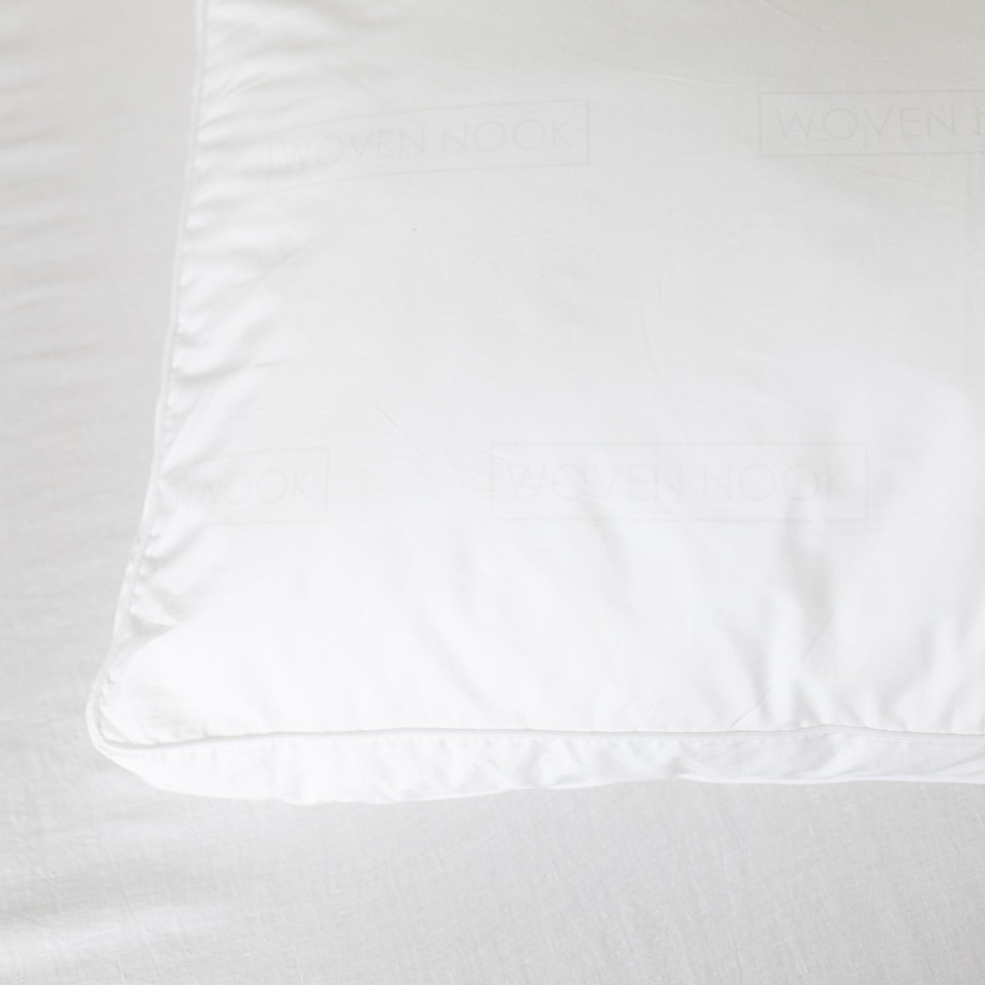 White faux down pillow insert with visible stitching and a smooth polyester cover.