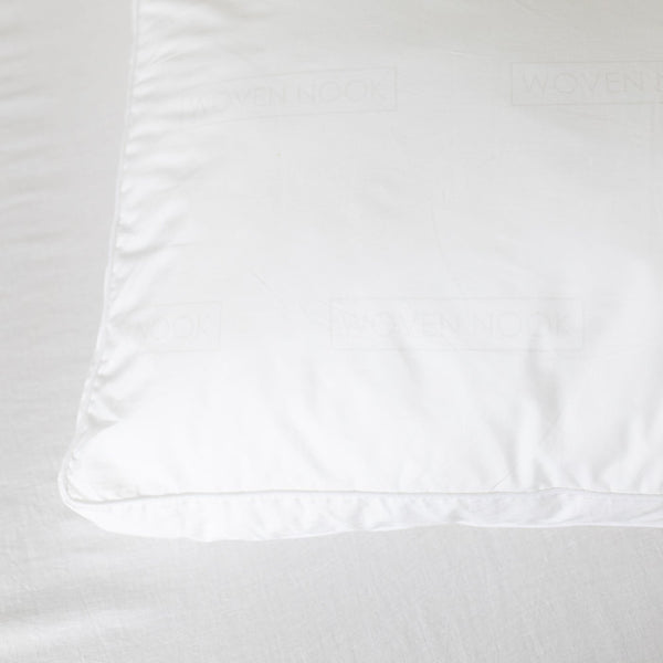 White faux down pillow insert with visible stitching and a smooth polyester cover.