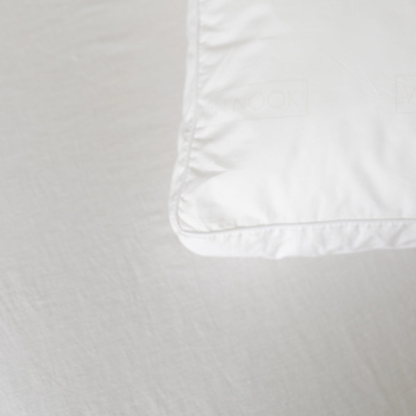 White faux down insert pillow sham with stitched edge detail.
