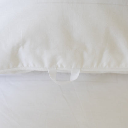 White quilted duvet insert with corner ties visible on cream-colored fabric.