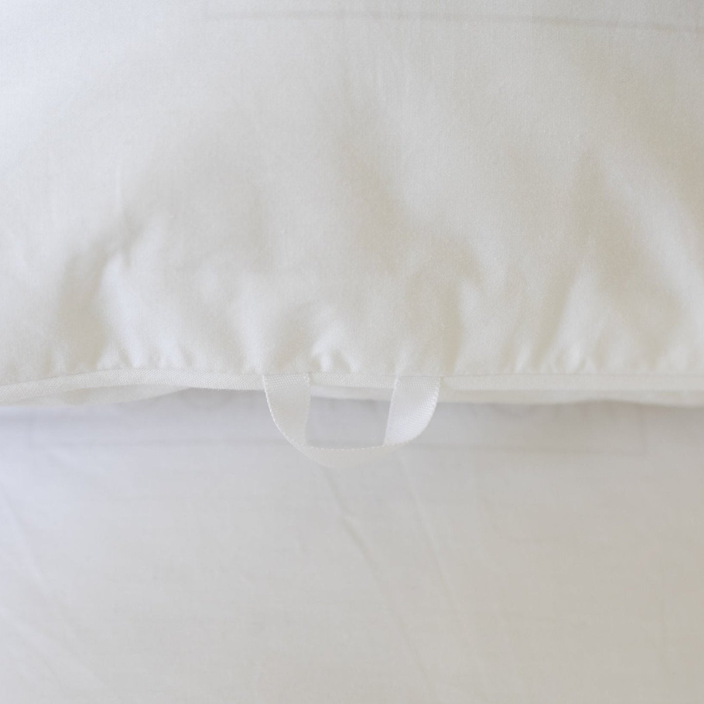 White duvet cover with interior tie closures, shown from above with bundled duvet insert inside.