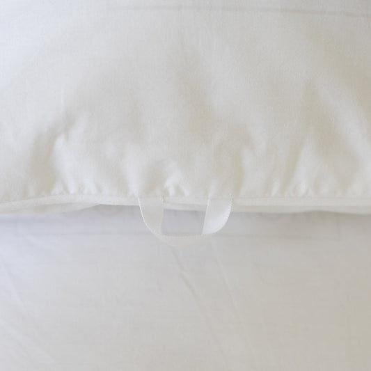 White duvet cover with interior tie closures, shown from above with bundled duvet insert inside.