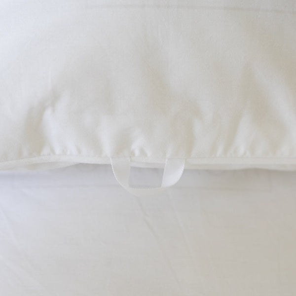 White duvet cover with interior tie closures, shown from above with bundled duvet insert inside.