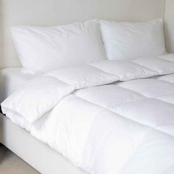 White quilted king duvet insert displayed on a bed with two pillows.