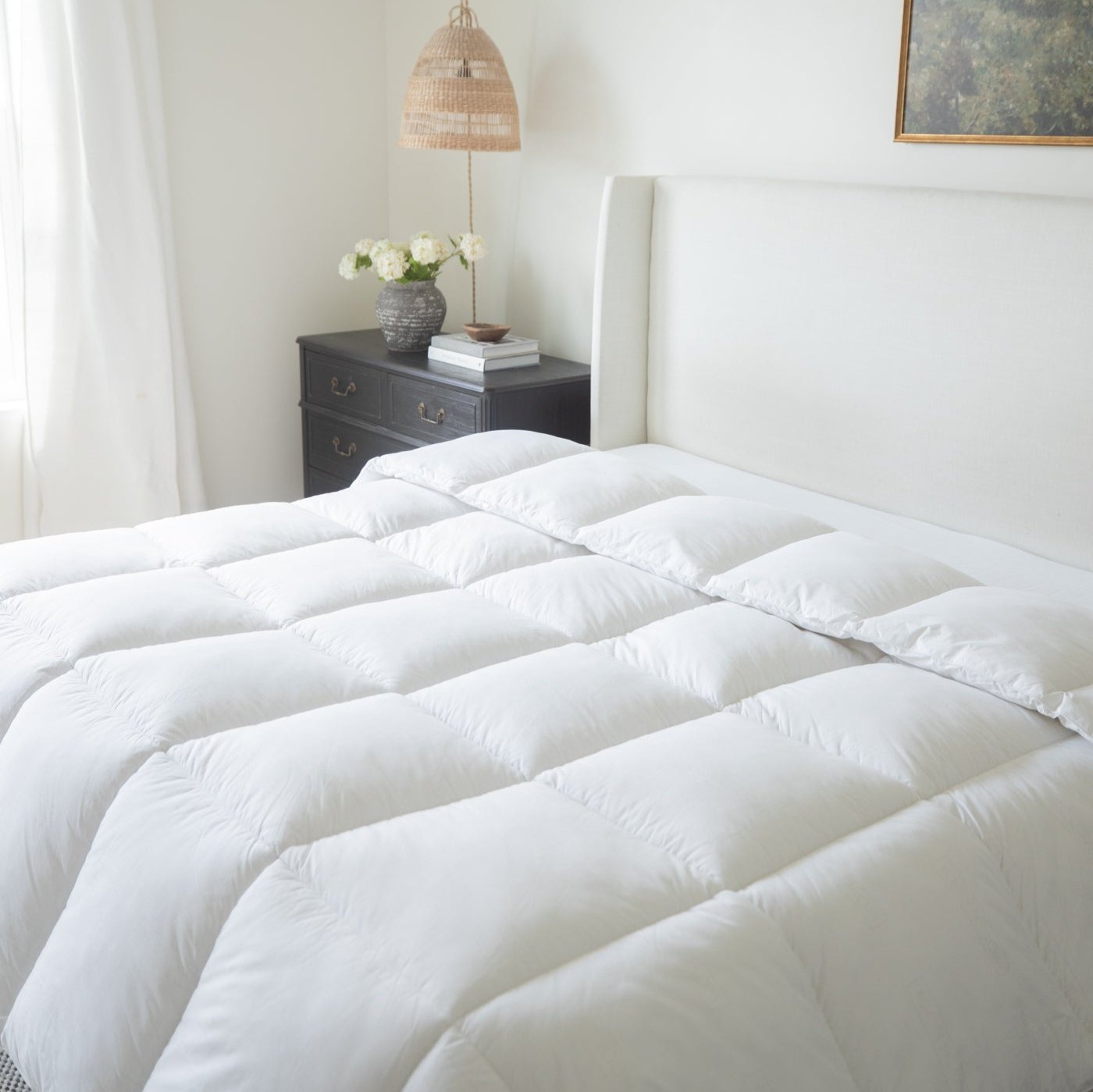 White quilted king duvet insert with box stitch pattern displayed on bed.