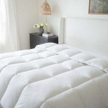 White quilted king duvet insert with box stitch pattern displayed on bed.