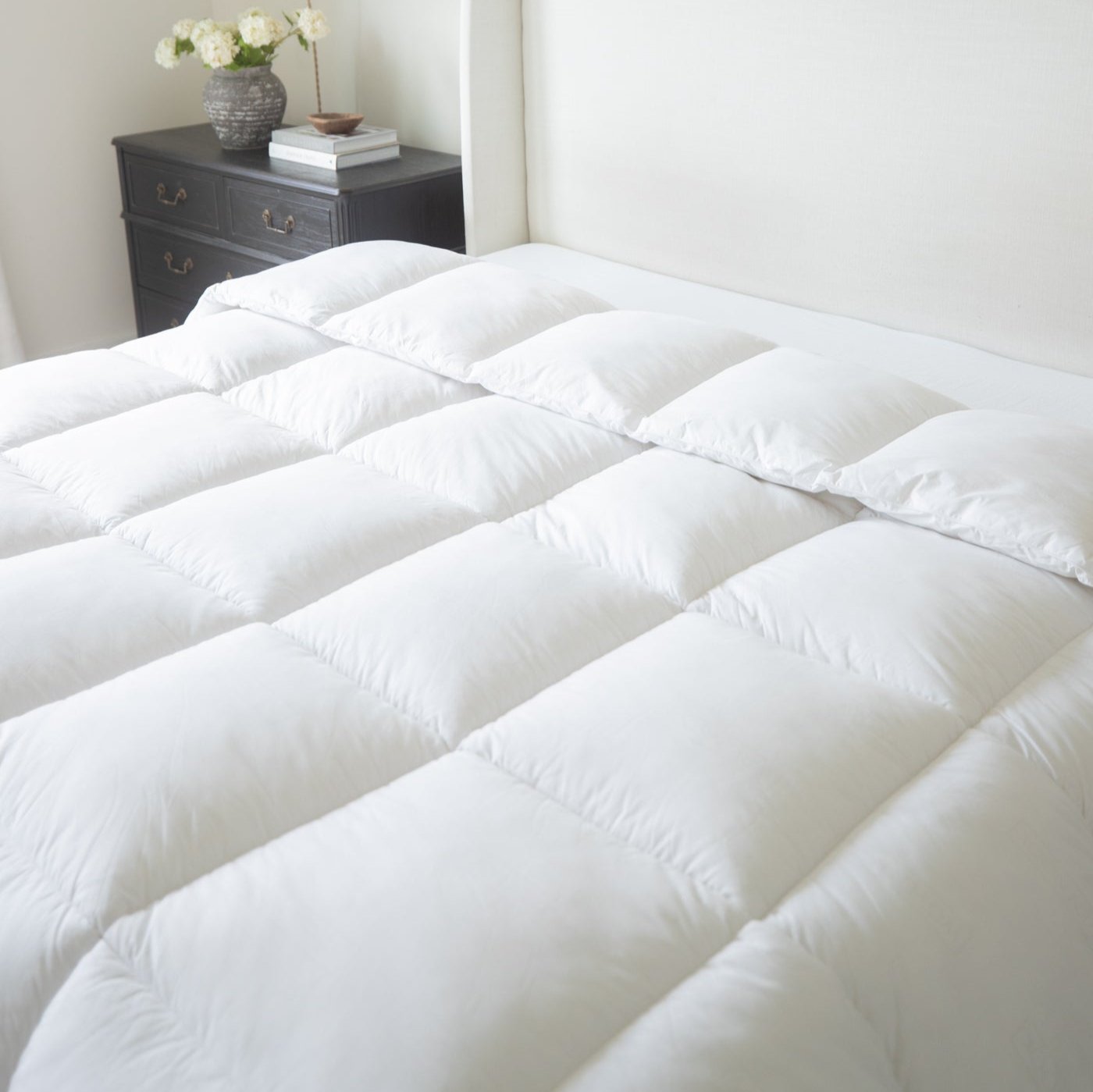 White quilted king duvet insert with baffle box design displayed on a bed.