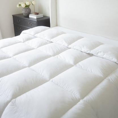 White quilted king duvet insert with baffle box design displayed on a bed.