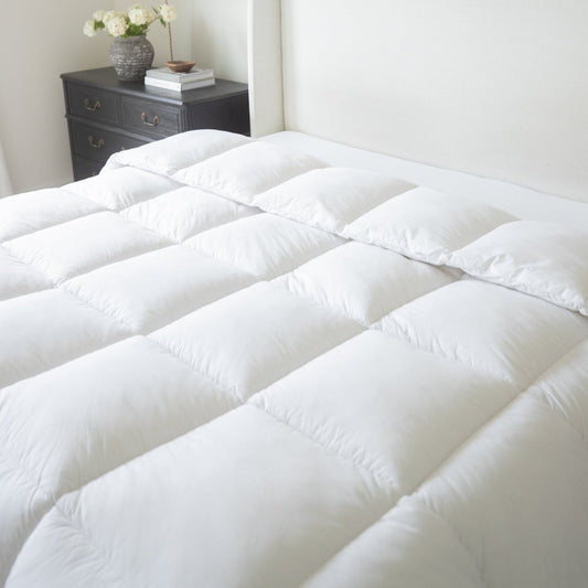 White quilted king duvet insert with baffle box design displayed on a bed.