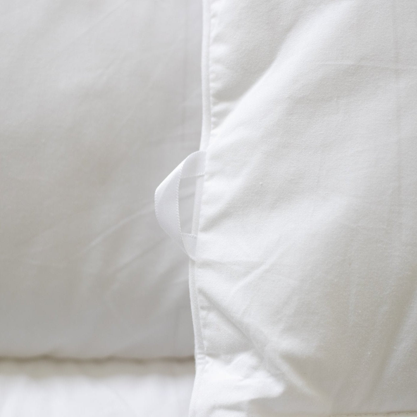 White duvet cover with internal tie closure detail and soft fabric texture.