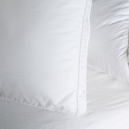 White faux down king sham insert with piped edge detailing and visible fill.