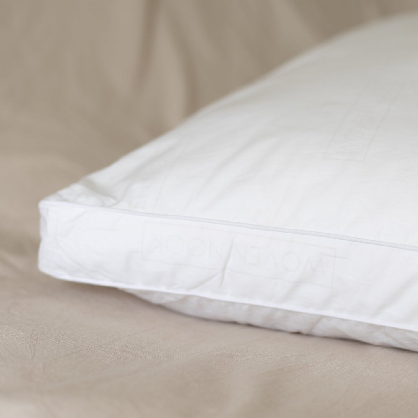 White rectangular pillow insert with quilted surface and visible seam along edge.
