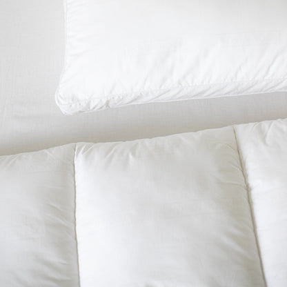 White duvet insert and cream pillowcase displayed flat on neutral background.
