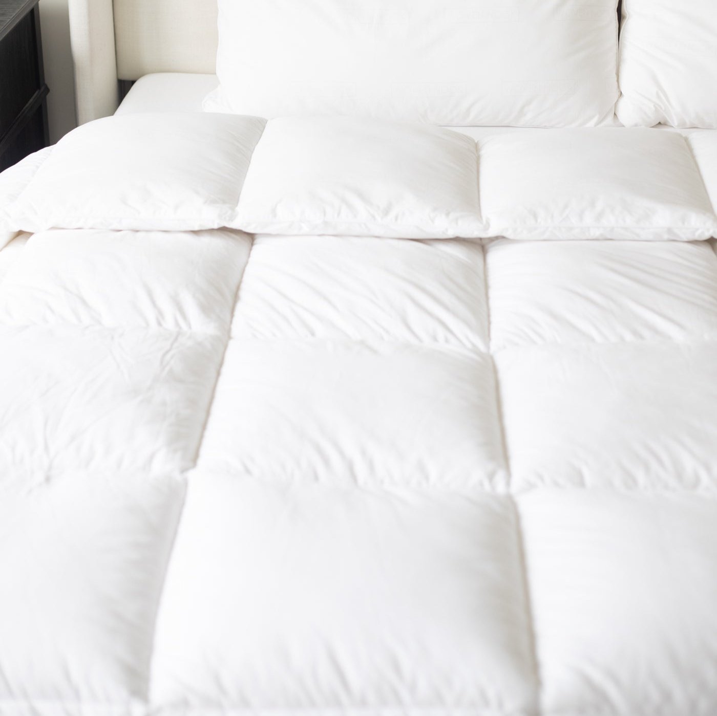 White quilted king duvet insert displayed on bed with matching pillows.