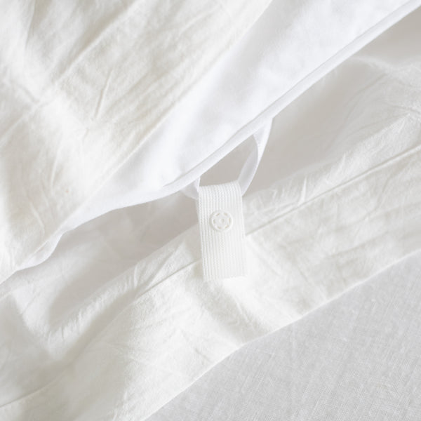White duvet insert with corner ties and quilted texture detail.