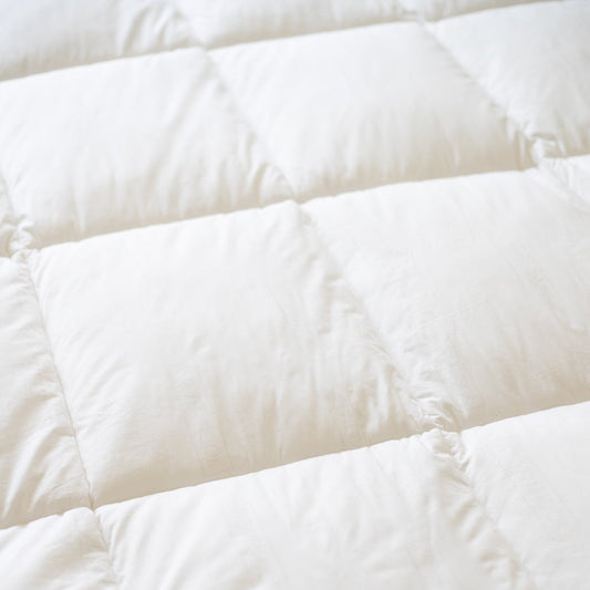 White quilted duvet insert with baffle-box stitching pattern and filled compartments.