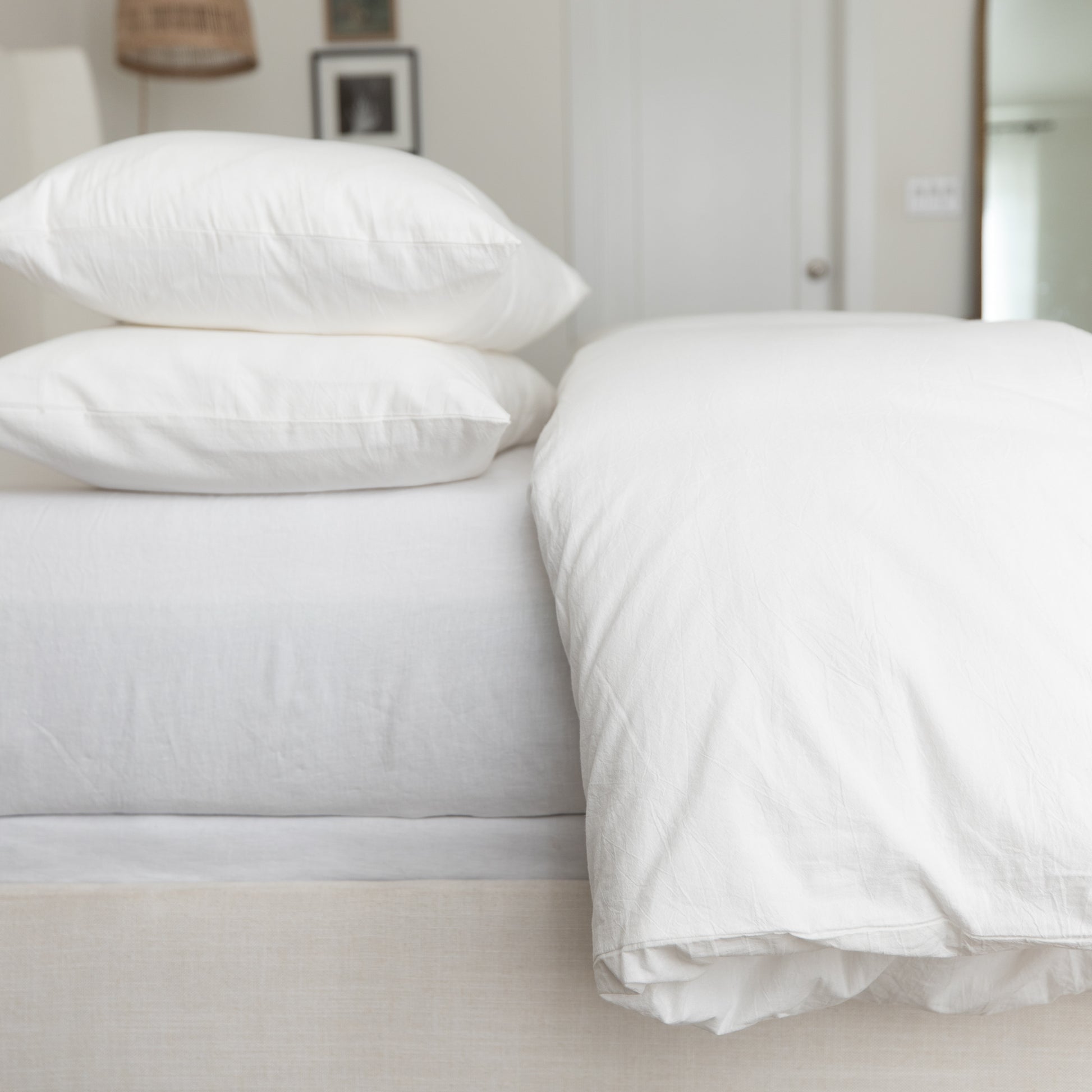 White king duvet cover set styled on bed with two pillows and fitted sheet.