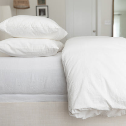 White king duvet cover set styled on bed with two pillows and fitted sheet.