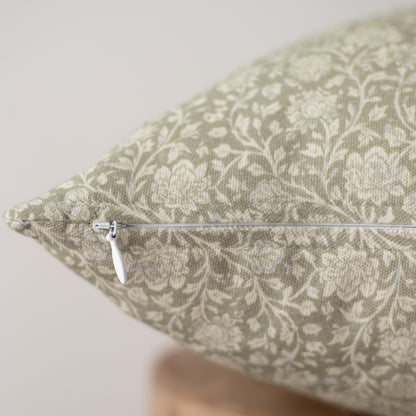 Beige and cream damask patterned pillow with white zipper closure detail visible on side.
