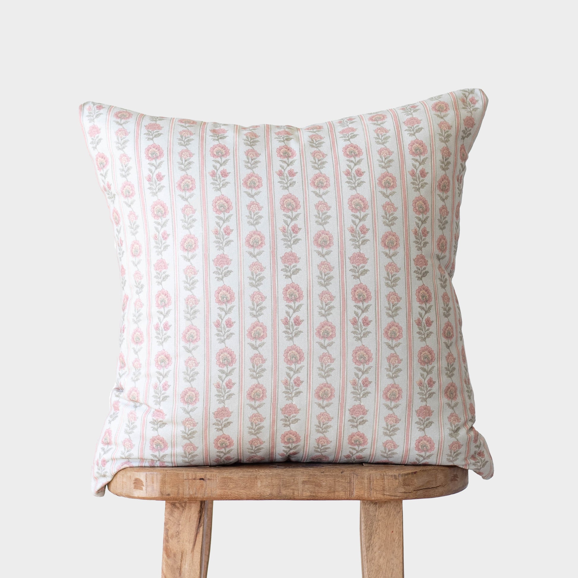 Elise pillow with vertical stripe pattern featuring pink floral motifs on white background.