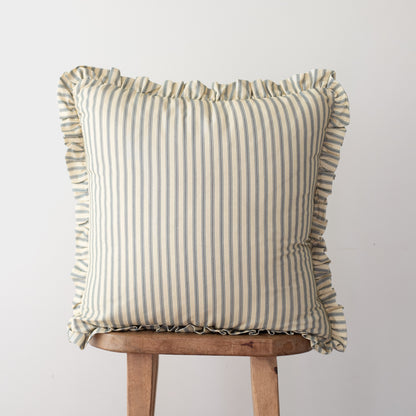 Square throw pillow with vertical stripe pattern and ruffled edges on all sides, displayed on wooden stool.
