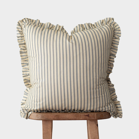 Cream and blue striped pillow with ruffled edges on all sides, displayed on a wooden stand.