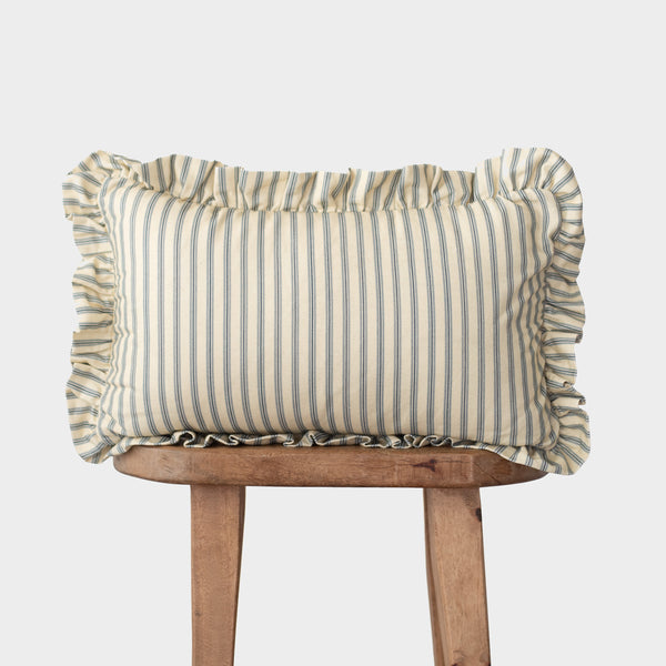 Rectangular pillow with blue and cream vertical stripes and ruffled edges on all sides, displayed on wooden legs.