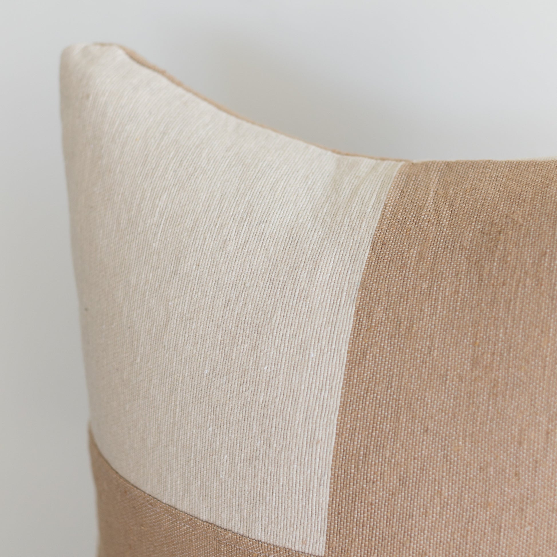 Tan and cream woven cushion cover with vertical stripe pattern, 22 inches.