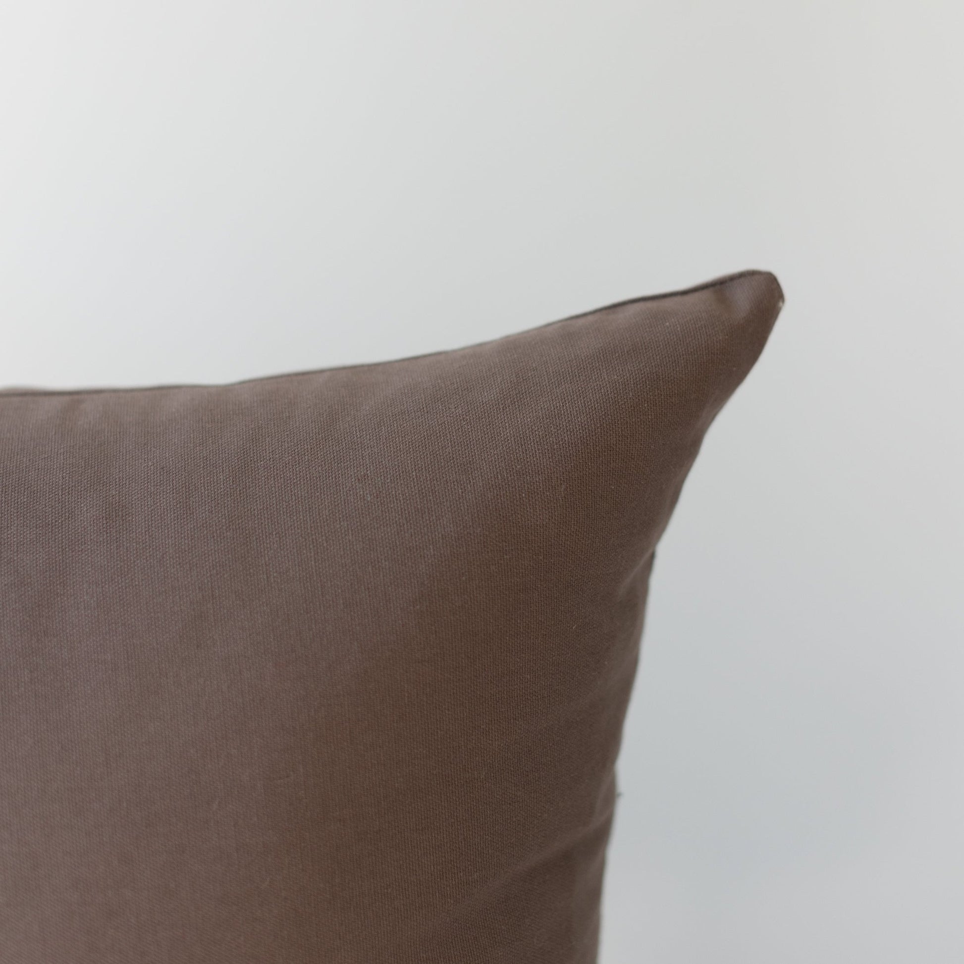 Mocha brown pillow cover with textured weave fabric and envelope flap closure.