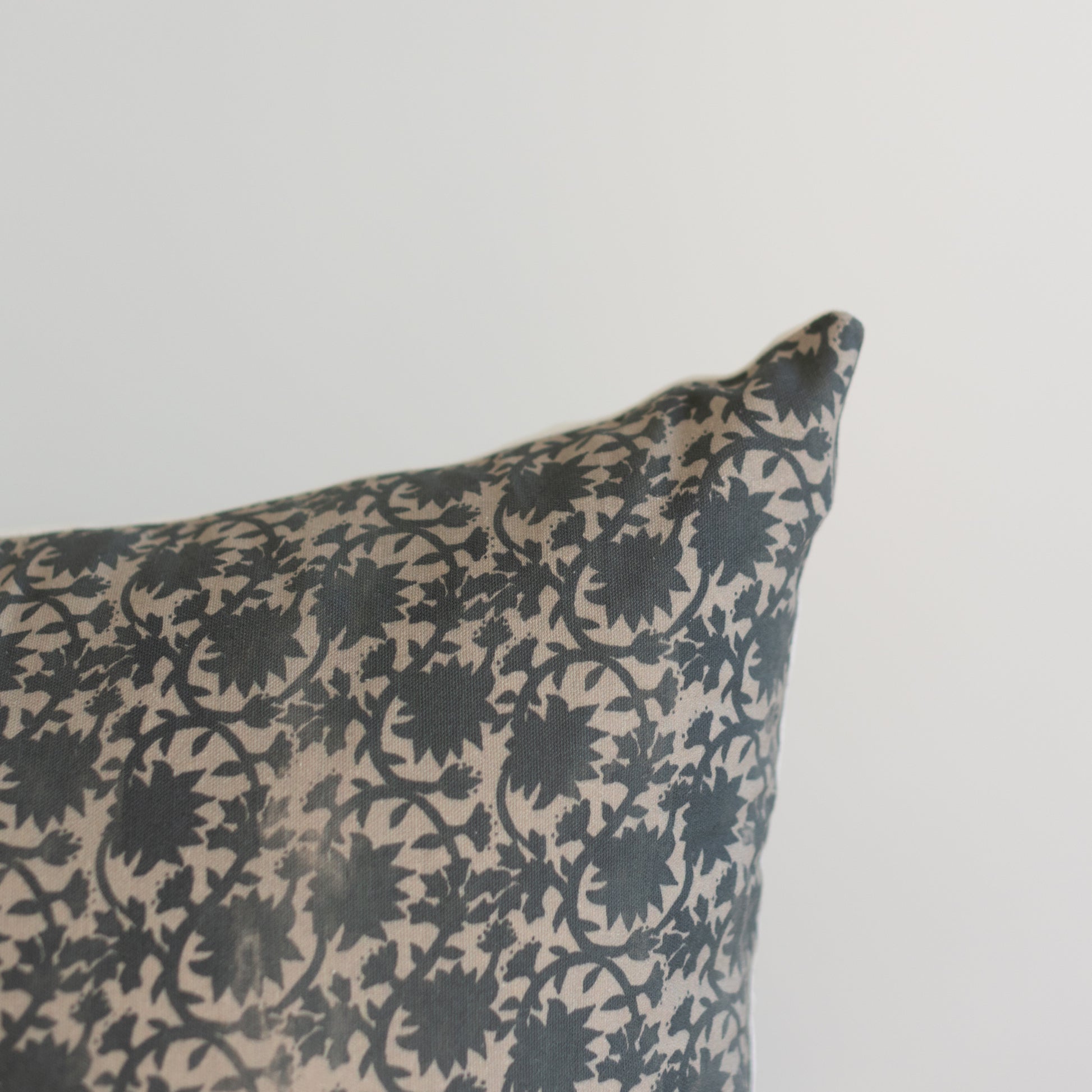 Rectangular pillow with dark blue and cream floral damask pattern, 12x20 inches.