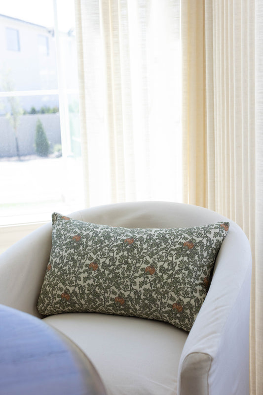Rectangular pillow with green and cream botanical print featuring gourds and ivy vines with rust-colored accents.
