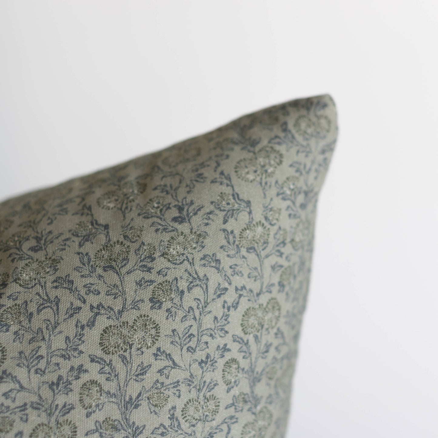 Green and blue floral patterned pillow cover with botanical print design.