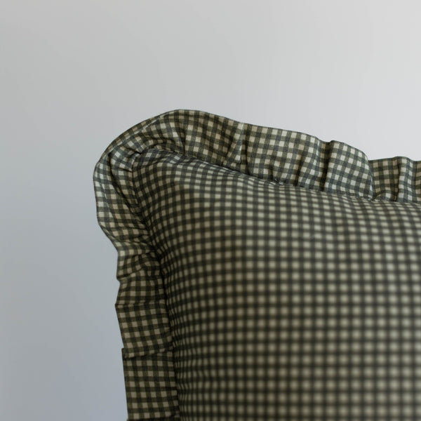 Green and white mini gingham ruffle with gathered fabric detail on light gray background.