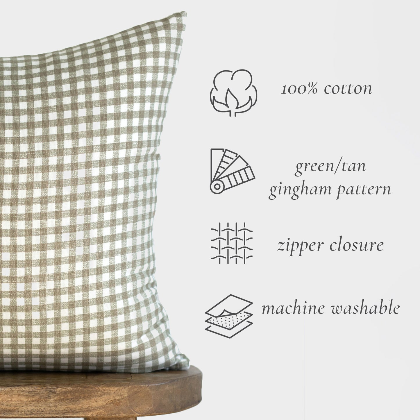 Green and white gingham patterned pillow with zipper closure on wooden base.