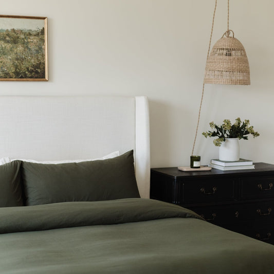 King duvet cover set in olive green on bed with matching pillowcase.